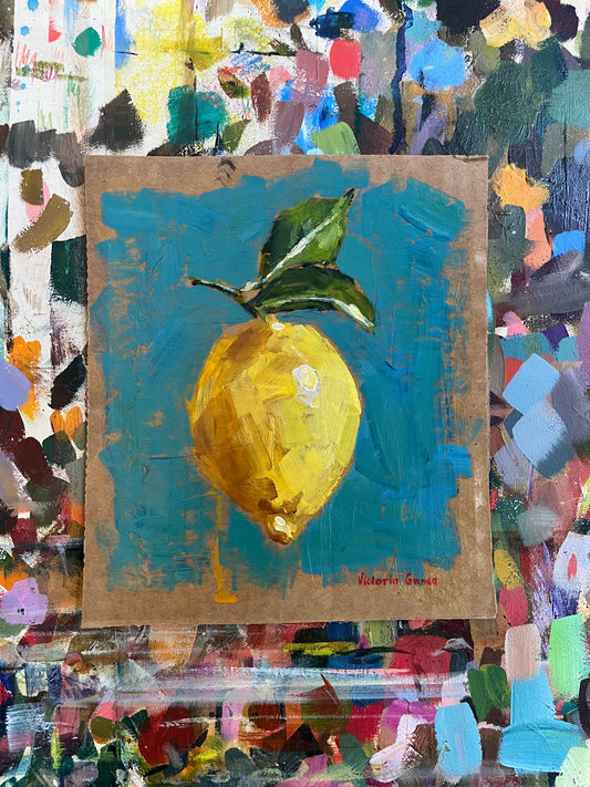 A painting of a lemon with a green leaf on a blue background, executed in acrylic on cardboard.