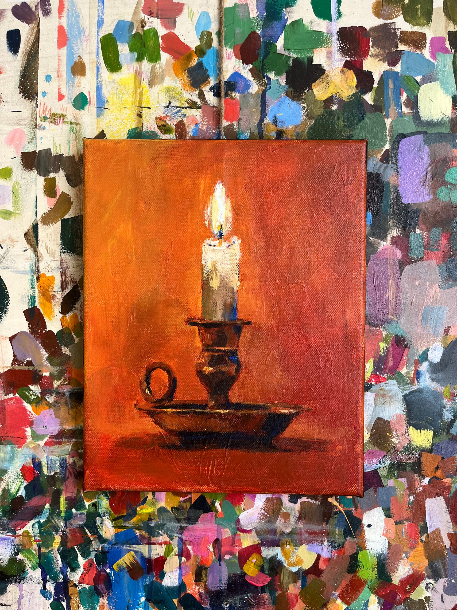A painting of a lit candle in a candle holder
