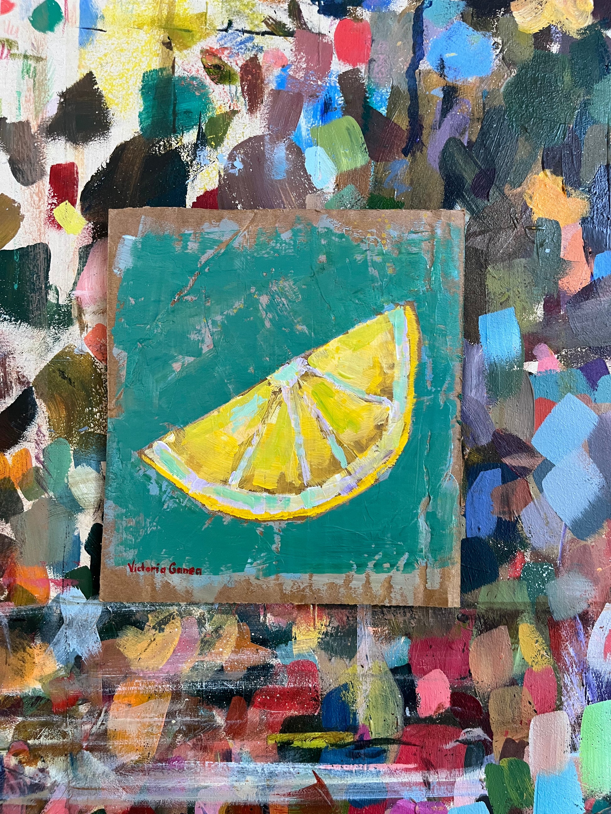 A piece of visual art featuring an abstract, vibrant green background with a realistic slice of lemon in the center.